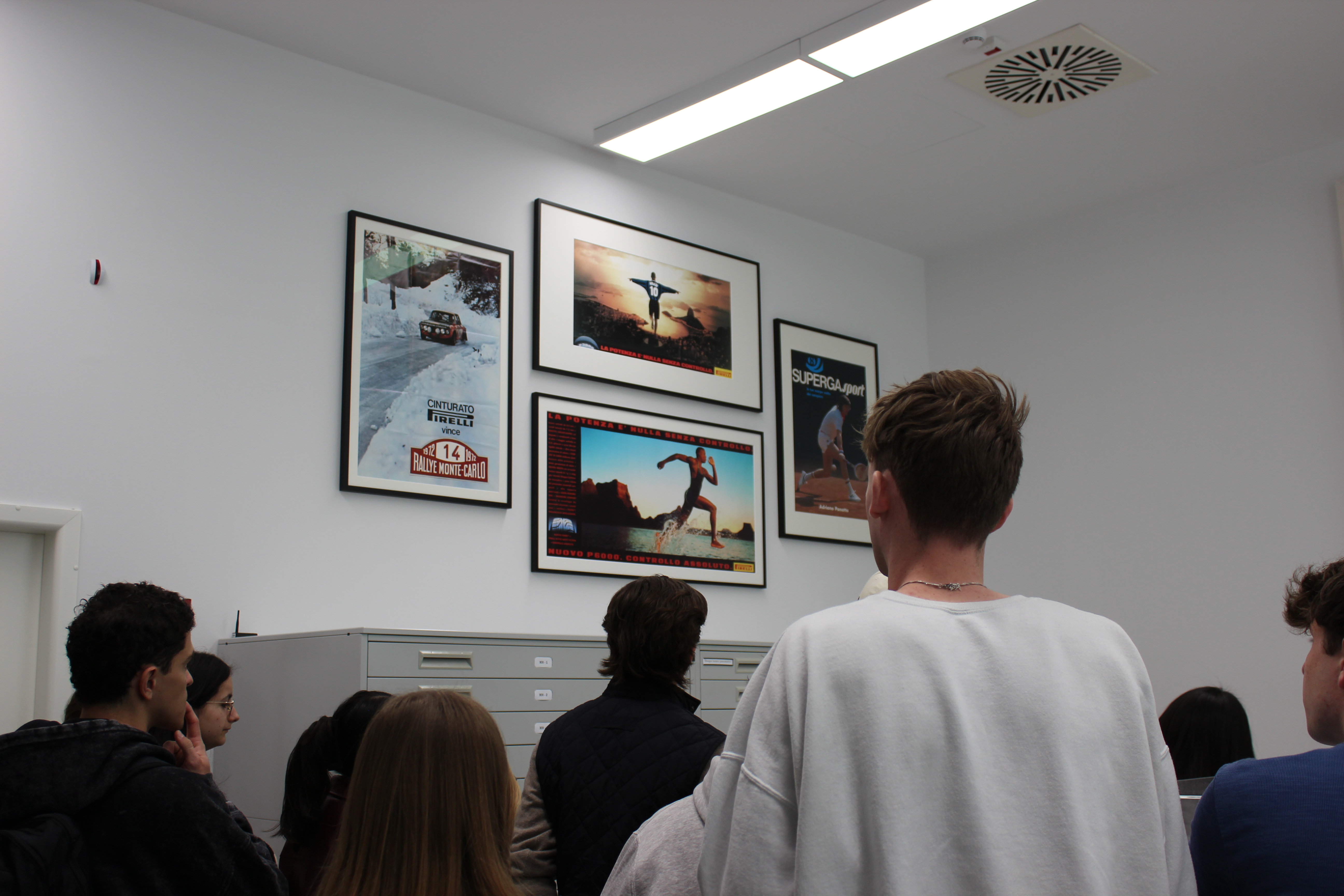 Students looking at some Pirelli advertisments in the archive.